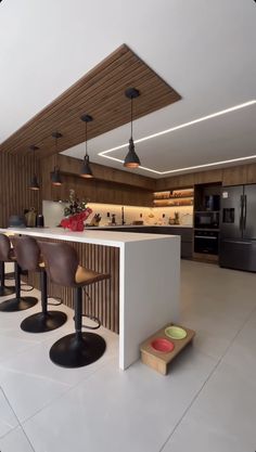 a kitchen with an island and stools in it