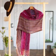 This gorgeous shawl combines a beautiful palette with rustic textures to give you the perfect statement piece. Raquel and Gregor hand-weave it from a baby alpaca blend in a bright combination of midnight blue deep pink and garnet with details in light brown. Wear it as a shawl on cool summer nights or an oversized scarf in winter weather. Raquel and Gregor label their pieces with the name Silpa which is the Aymara word for comfort pleasure and softness. The couple aims to preserve their homeland Pink Shawl, Purple Wrap, Valley Flowers, Alpaca Scarf, Unique Brooch, Variegated Yarn, Oversized Scarf, Cool Summer, Deep Pink