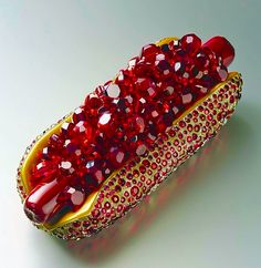 a hot dog covered in red and gold confetti