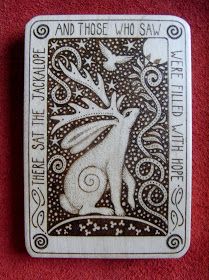 a playing card with an image of a rabbit in the middle and stars above it