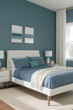 a bedroom with blue walls and white furniture