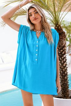 Infuse your beach look with a pop of color in our Bright Blue Ruched Shoulder Mini Cover-Up. The ruched shoulder detailing adds a touch of modern flair to this breezy piece, ideal for seaside lounging or poolside elegance. The bright blue hue captures the essence of sun-filled days, making this cover-up a perfect choice for your beach escapades. Product code: CAA07B4B015TT Features:  Woven  V-neckline  Sleeveless  Ruched shoulder detail  partial front buttons  Mini Wash Method: Regular Wash Mate Breezy V-neck Tops For Beach, Bohemian Beach Top, Blue Beach Tops With Upf 50+, Blue Tops For Beach With Upf 50+, Light Blue Summer Tops For Vacation, Casual Summer Tops For Pool, Light Blue Summer Vacation Tops, Casual Summer Pool Tops, Beachy Upf 50+ Tops For Spring