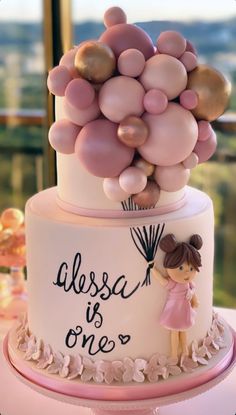 there is a cake with balloons on it that says, alessa is one's