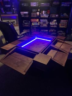 a table that has some kind of blue light on it in the middle of a room