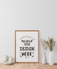 a white vase sitting on top of a wooden table next to a framed sign that says mock up your design here