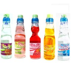 four different types of sodas are lined up in a row on a white background