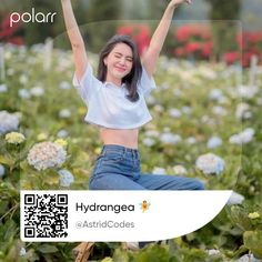 a woman sitting in a field with her arms up