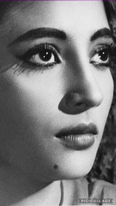 black and white photograph of a woman's face with her eyes wide open, looking directly into the camera