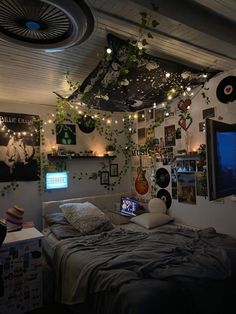 a bed room with a neatly made bed and lots of plants hanging from the ceiling