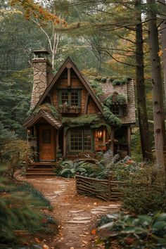 a small house in the woods with lots of greenery on it's roof