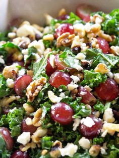 a salad with grapes, walnuts and feta cheese on it in a bowl