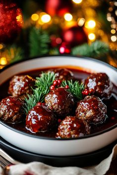 a white bowl filled with meatballs covered in sauce