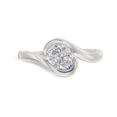 a white gold ring with an oval cut diamond in the center and twisted band around it