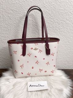 Coach Mini City Tote With Bow Tie Print Brand new with tags Color: Im/Chalk/Wine Multi 100% Authentic Limited Edition Product Details Printed coated canvas and smooth leather Inside snap pocket Handles with 7" drop 9" (L) x 8" (H) x 4 1/4" (W) Style No. CN681 Coach Mini Tote Bag, Coach Mini City Tote, Coach Small City Tote, Coach Bow Bag, Coach Bags Tote, Mini Coach Bag, Coach Tote Bag Outfit, Must Have Bags For Women, Cute Coach Bags