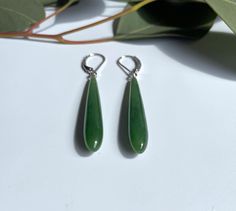 Long slim earrings featuring natural Canadian nephrite jade stones. Available in sterling silver or vermeil (gold-plated sterling silver). Earrings measure 40mm long. Comes in a handcrafted wooden gift box. 30 day satisfaction guarantee! Jade is a natural stone, so the shade of color may vary slightly. All of our jade is grade A, unless otherwise noted. It is 100% Pure Nephrite Jade, with no treatments whatsoever. What is Jade? Jade is one of two gemstones, nephrite jade or jadeite jade. Nephrit Jade Charm, Silver Gift Box, Chinese Jade, Jade Bangle, Jade Earrings, Nephrite Jade, Jade Ring, Jade Bracelet, Jade Carving