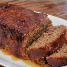 sliced meatloaf sitting on top of a white plate