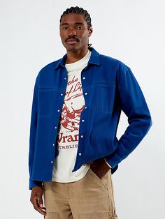 The Wrangler x PacSun Long Sleeve Overshirt combines durability with style in a relaxed fit. Made from a heavyweight textured fabric, it features a collar, patch chest pockets, a snap-button front closure, side seam pockets, and a Wrangler x PacSun woven label at the hem for a touch of authenticity. Blue Overshirt Men Outfit, Blue Workwear Shirt With Buttoned Pockets, Blue Button Closure Streetwear Shirt, Blue Long Sleeve Flannel Shirt With Button Closure, Washed Blue Button-up Shirt With Patch Pockets, Pacsun Mens, Wrangler Shirts, Outfit Inspo Fall, Chest Pocket