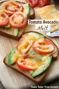 two slices of toast with tomatoes, avocado and cheese on them