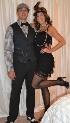 a man and woman posing for a photo in front of a white curtain, dressed up as flap dancers