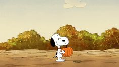 a cartoon dog holding a pumpkin in his hand while standing on the ground with trees behind him