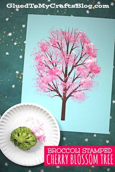 a paper plate with broccoli blossom tree on it next to a piece of paper