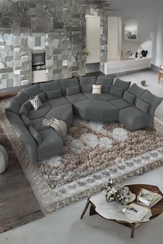 a large sectional couch sitting on top of a rug in a living room