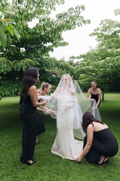 the bride is getting ready to walk down the aisle with her bridal party in the background