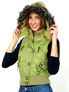 Hooded vest ideal for winter cold days. It fits perfectly into the sporty casual style of leisure. The delicate green shade gives it a dose of playfulness on winter gloomy days. The hood is rich in gray fur. Composition: Outside 100% nylon, Inside: 100% polyester, Charging: 70% down, 30% polyester Green Winter Vest For Cold Weather, Trendy Green Winter Vest, Trendy Green Vest Outerwear, Sporty Casual Style, Green Vest, Gloomy Day, Sporty Casual, Winter Cold, Hooded Vest