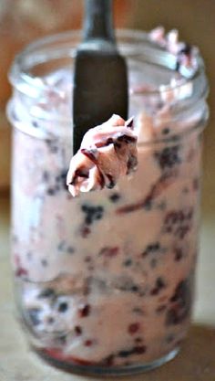 a spoon in a jar filled with food