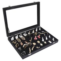 an open black jewelry box filled with lots of different types of rings and bracelets