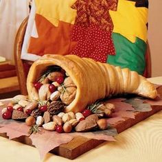 a crepe filled with nuts on top of a cutting board next to a pillow