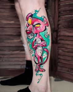 a person with a tattoo on their leg that has an image of a pink monkey