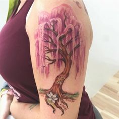 a woman with a tree tattoo on her arm