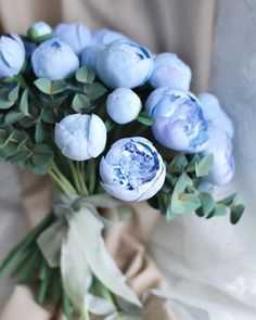 a bouquet of blue flowers sitting on top of a table