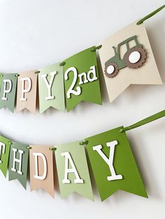 two green and white birthday banners with tractor on them, one says happy 2nd birthday