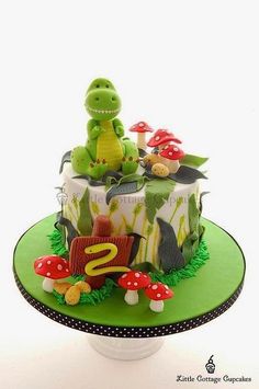 a birthday cake with a dinosaur on top