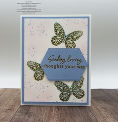 a close up of a greeting card with butterflies on the front and blue border around the edges