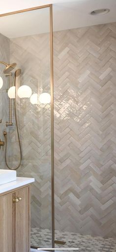 a bathroom with a sink, mirror and shower head in it's corner area