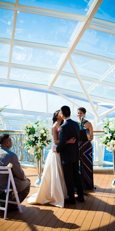 a bride and groom standing next to each other in front of a wedding ceremony setup