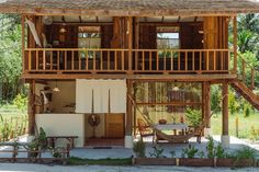 a wooden house sitting on top of a lush green field