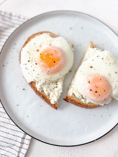 two eggs are on top of toast on a plate