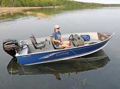 a man sitting in the back of a blue boat