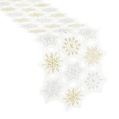 a white and gold table runner with snowflakes on it