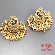 Saba Amrapali Inspired Golden Polki Chandbali Earrings Premium Quality Polki Chandbali Earrings Length: Approx. 2" Light-weight Push-Back closure Gold Finish on high-quality brass as the base metal, Kundan stones and Pearls Suitable for any traditional for contemporary attire and occasion In-stock & ready-to-ship **Color may vary slightly due to photography and lighting. Bridal Chandbali Earrings With Peacock Design For Festivals, Peacock Design Earrings For Festivals, Bridal Peacock Chandbali Earrings For Festivals, Festival Bridal Chandbali Earrings With Peacock Design, Peacock Design Earrings For Puja Festivals, Peacock Design Earrings For Festivals And Celebrations, Elegant Peacock Design Earrings For Puja, Festival Peacock Design Earrings For Puja, Traditional Green Pearl Earrings For Festivals