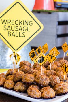 a plate full of food sitting on top of a table next to a sign that says wrecking sausage balls