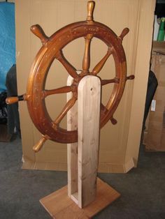 a wooden steering wheel on display in a room