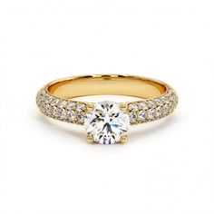 a yellow gold engagement ring with two rows of diamonds on the band and a round center stone