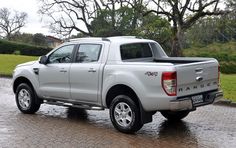 a silver pick up truck parked on the street