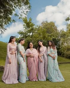 the bridesmaids are dressed in pastel saris