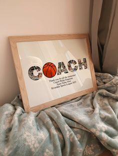 there is a framed sign that says coach with a basketball in the middle on top of it